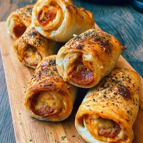 Protein-packed pepperoni pizza rolls with low calories on a serving plate.