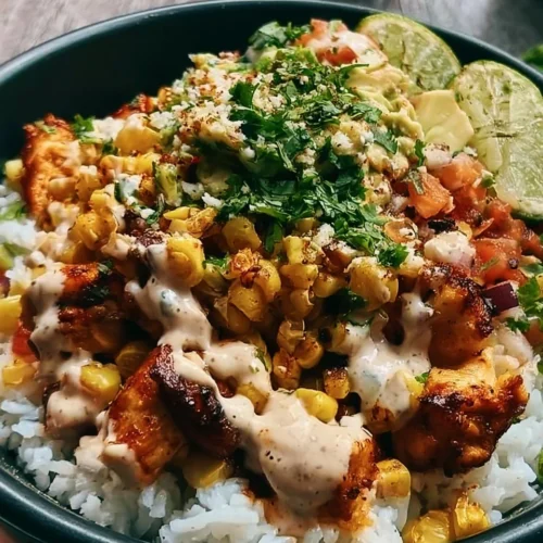 Delicious Street Corn Chicken Bowl served over rice with fresh toppings.